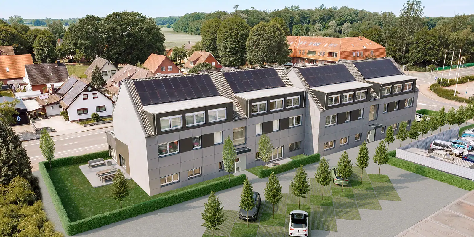 Mit KI bearbeitetes Drohnenbild eines Mehrfamilienhauses mit fertiggestellter Fassade und Außenanlagen